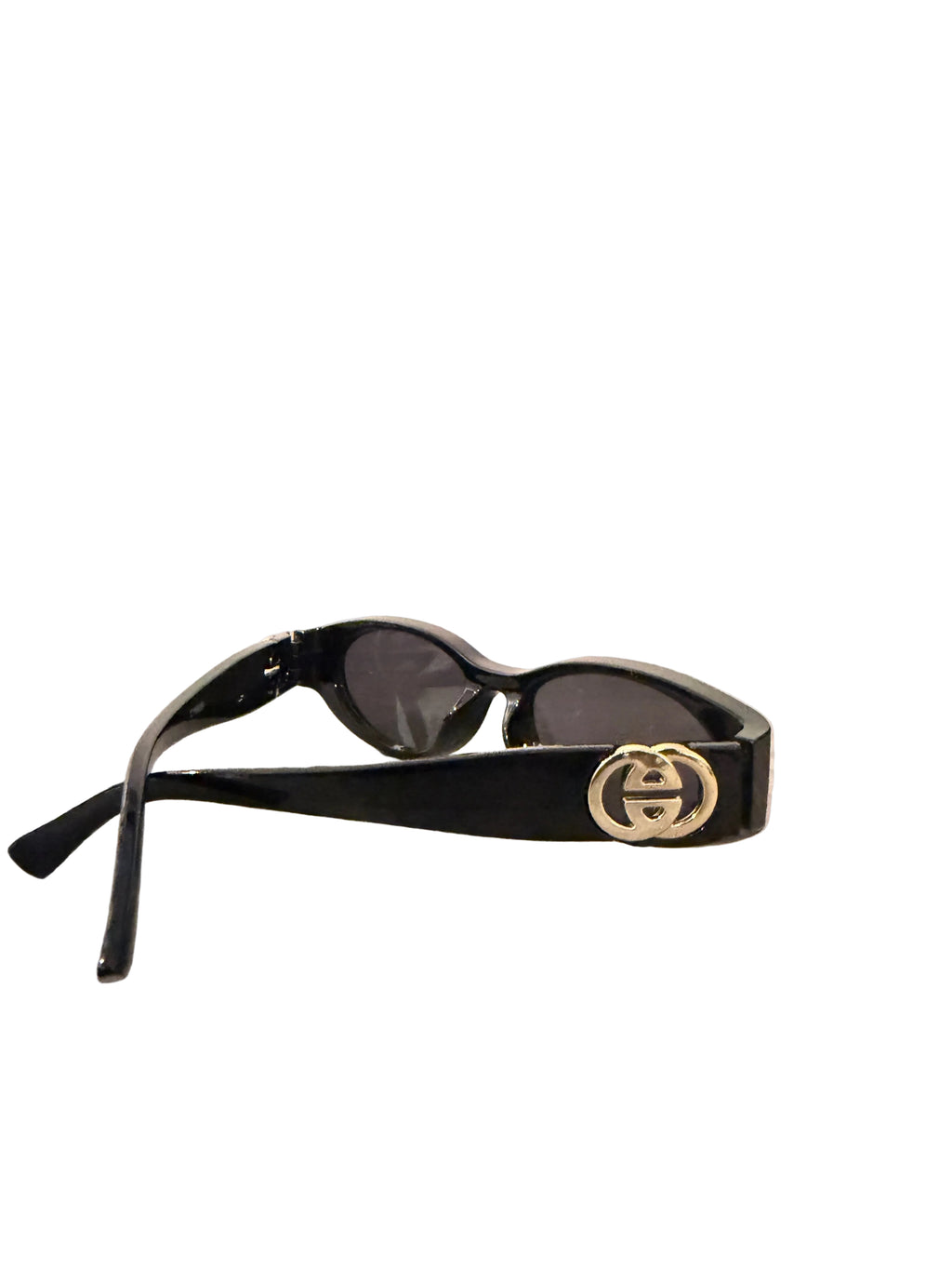 Black sunglasses with a gold logo on a wooden surface